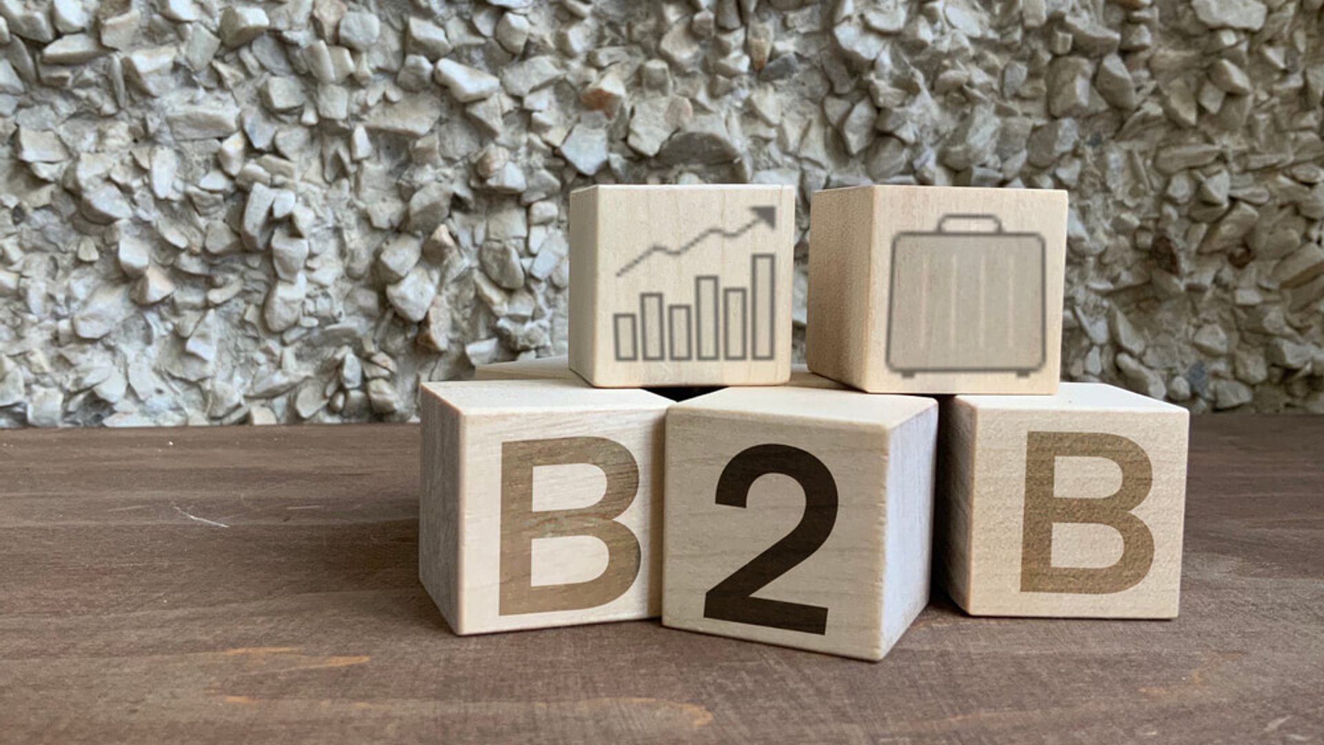 blocos de madeira com impressões de sacola, gráfico e as letras B2B, representando B2B ecommerce