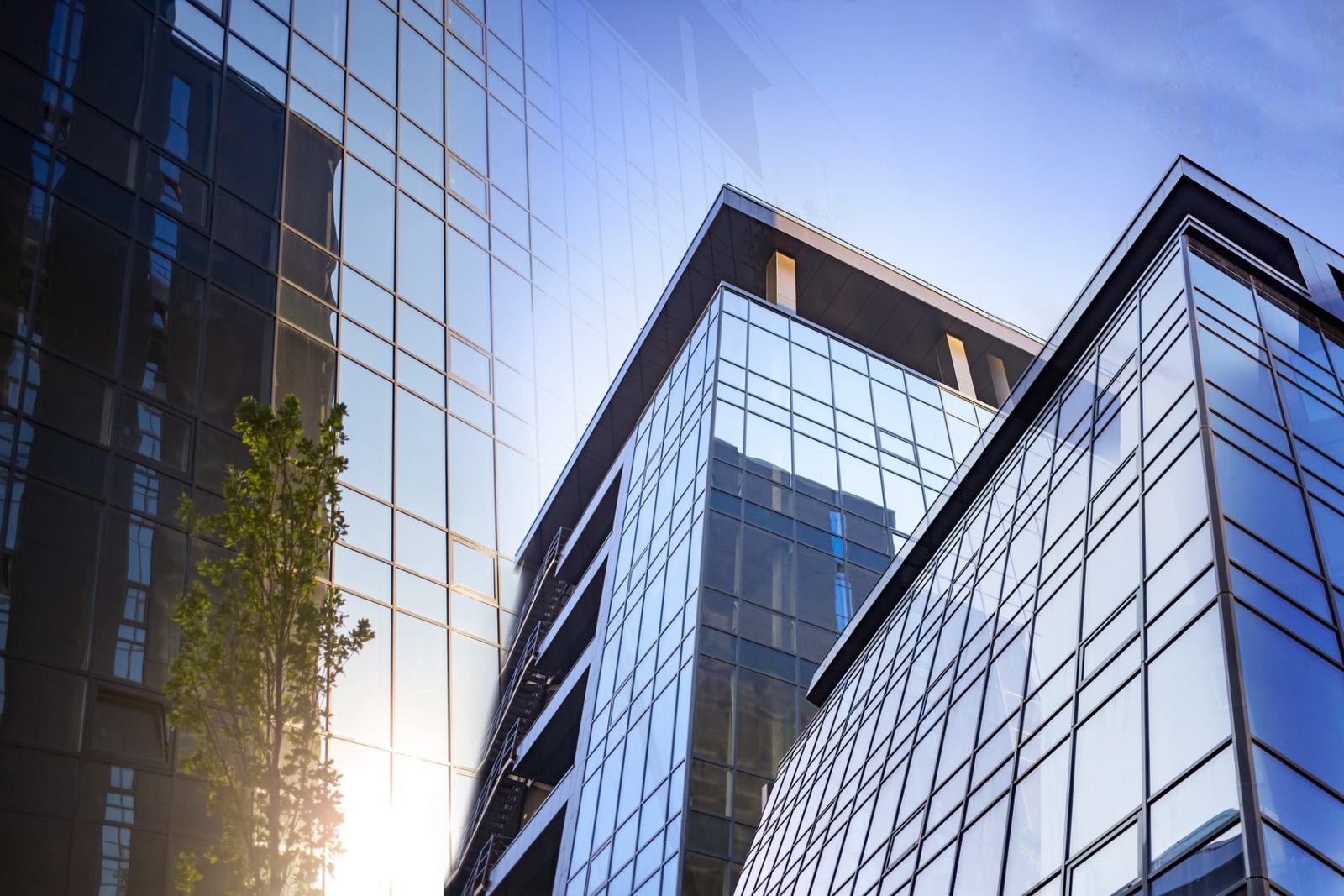 Abstract business modern city urban futuristic architecture background. Real estate concept, motion blur, reflection in glass of high rise skyscraper facade.