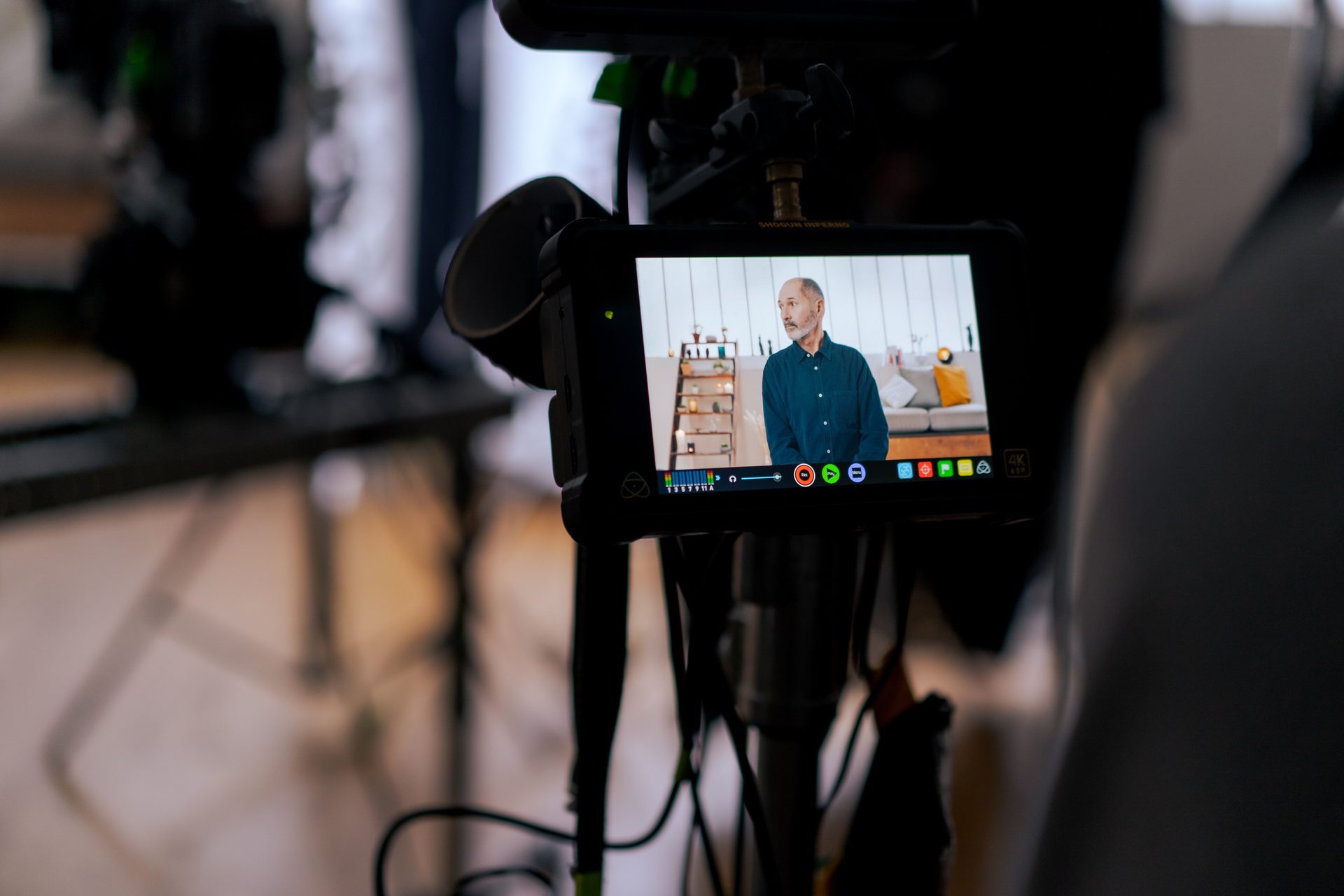 A camera is recording an older man teaching an online course