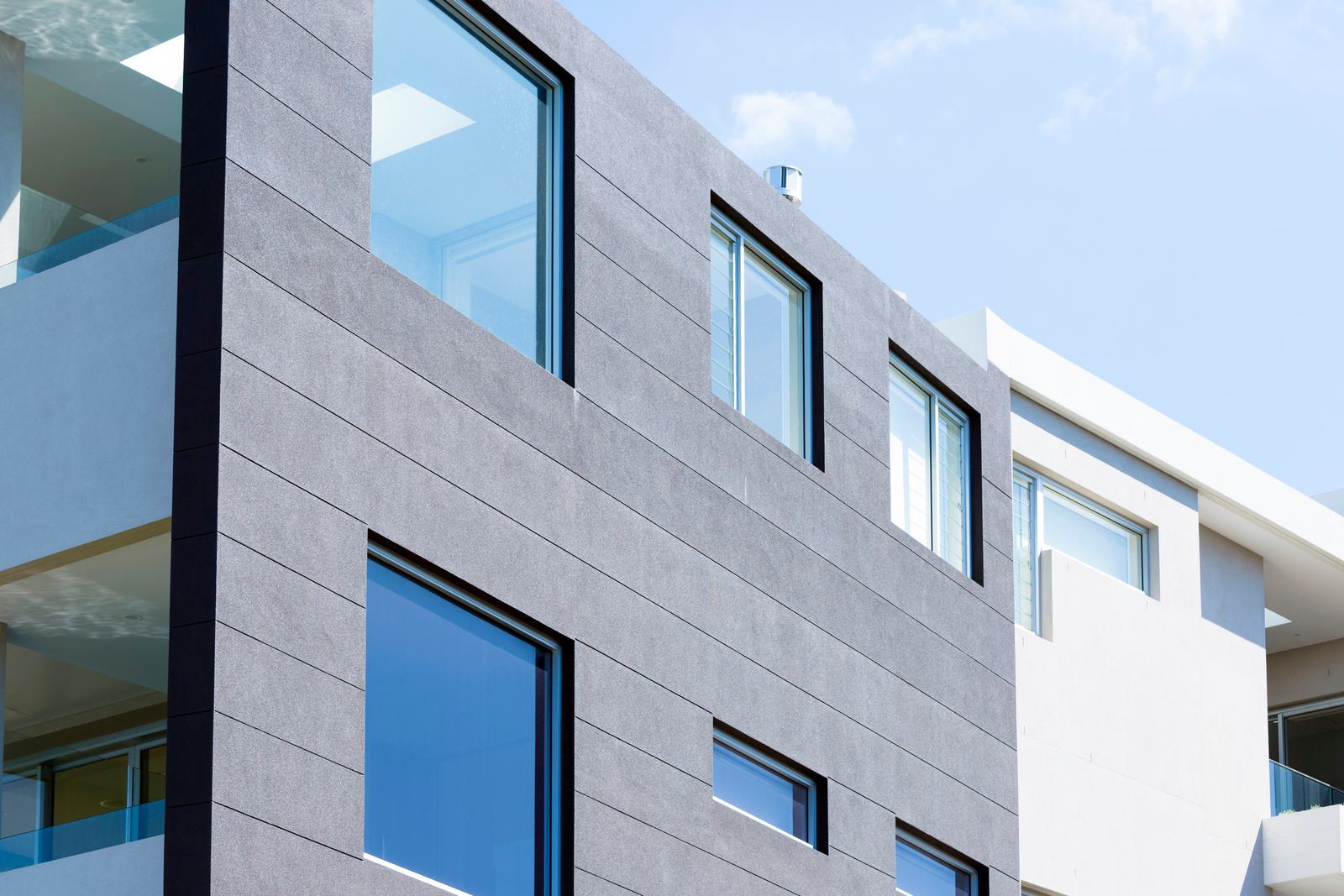 a modern grey and white building and the sky